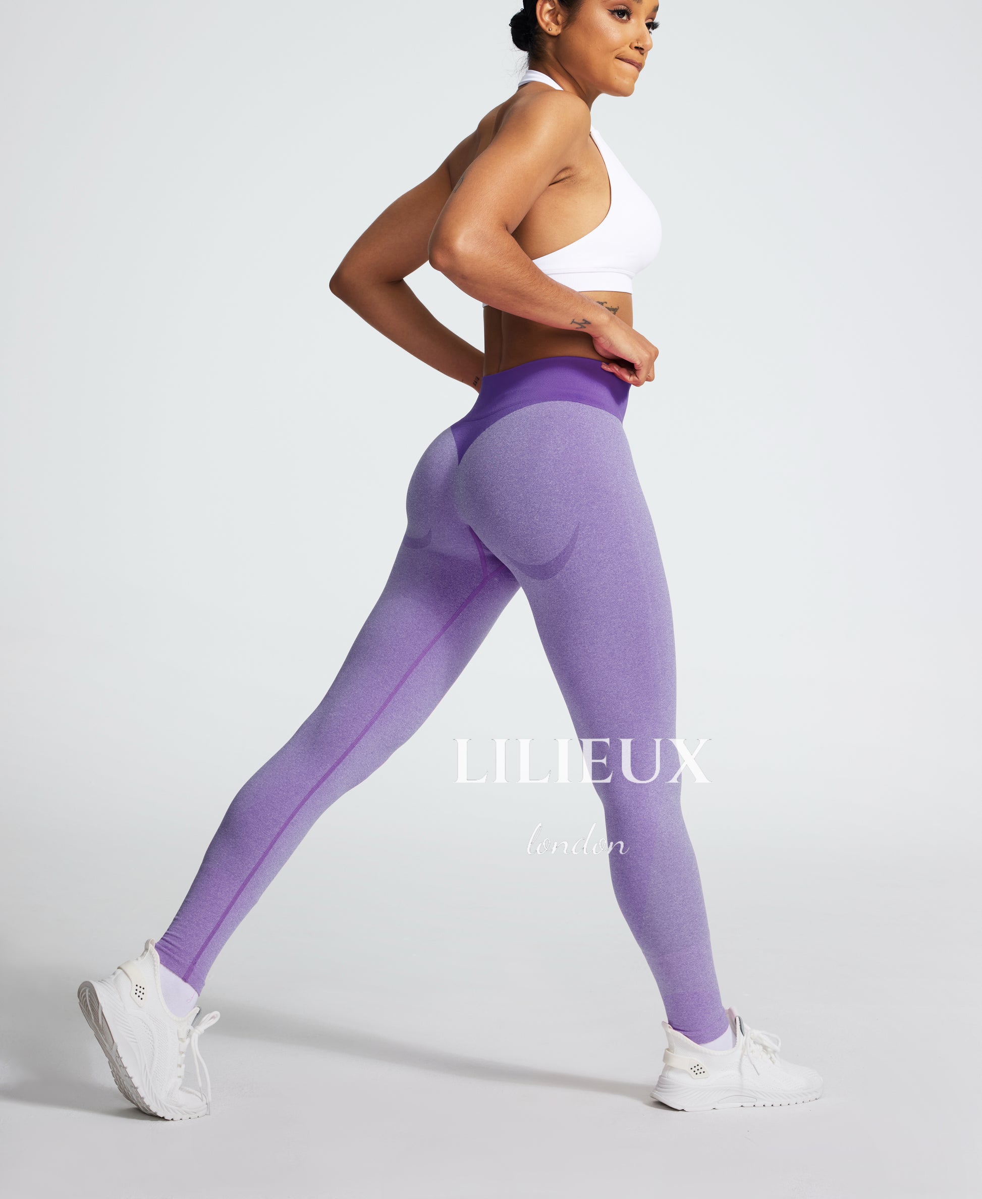 Purple seamless butt-lifting gym leggings with a high-waist ribbed waistband, designed for a sculpted and supportive fit during workouts.