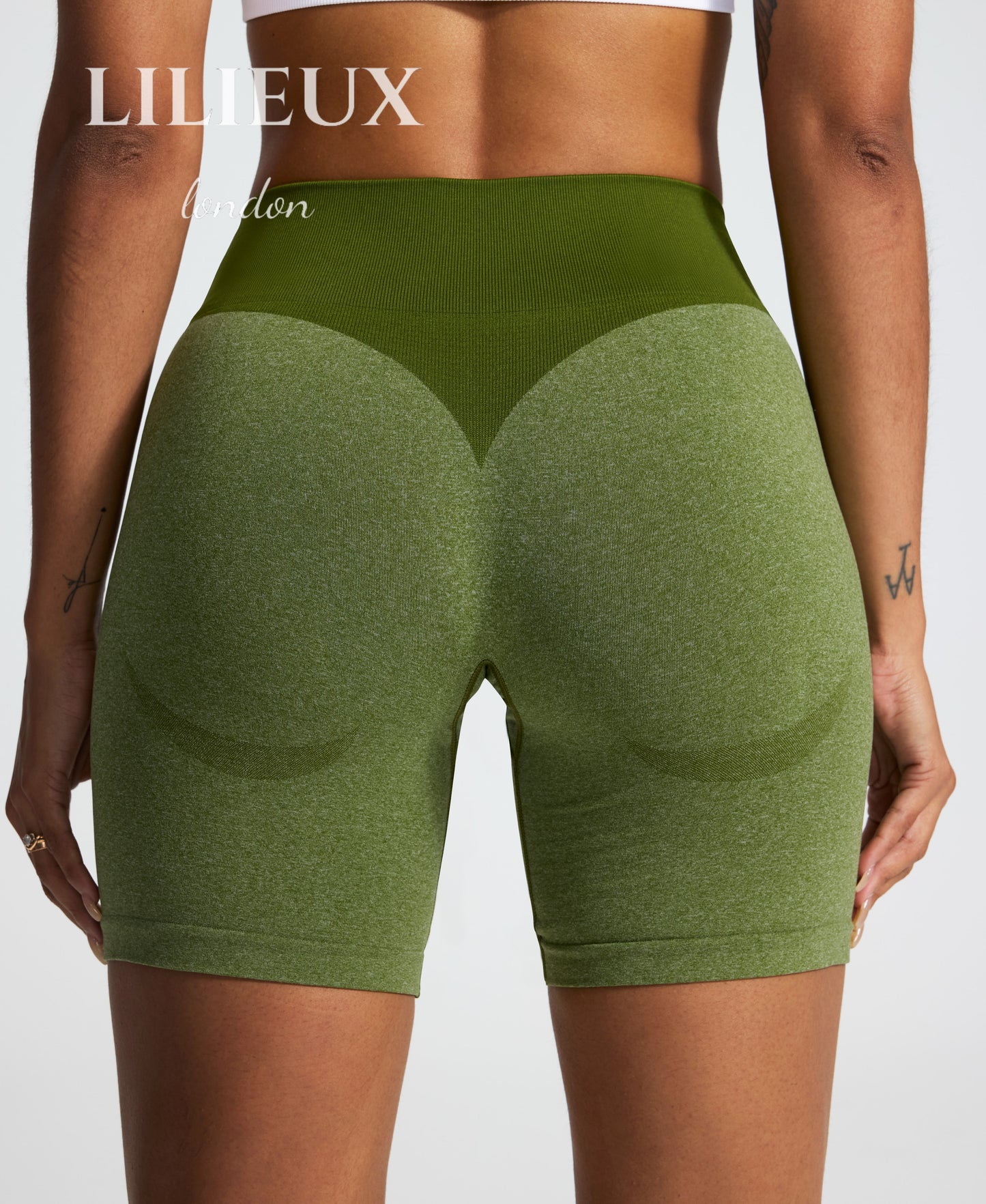 Back view of green seamless butt-lifting biker shorts with a high-waisted ribbed waistband, designed for gym workouts, activewear, and a sculpted fit.