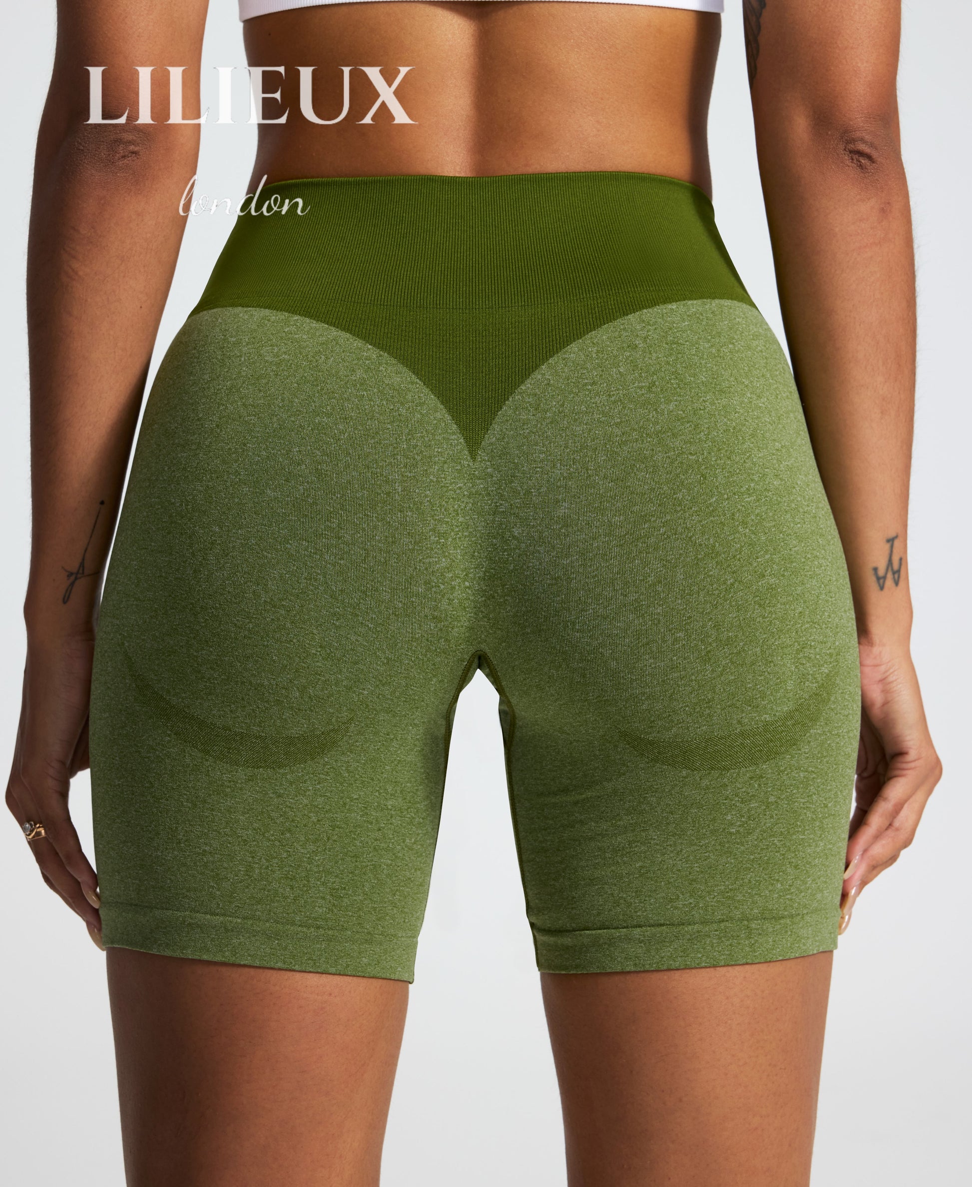 Back view of green seamless butt-lifting biker shorts with a high-waisted ribbed waistband, designed for gym workouts, activewear, and a sculpted fit.