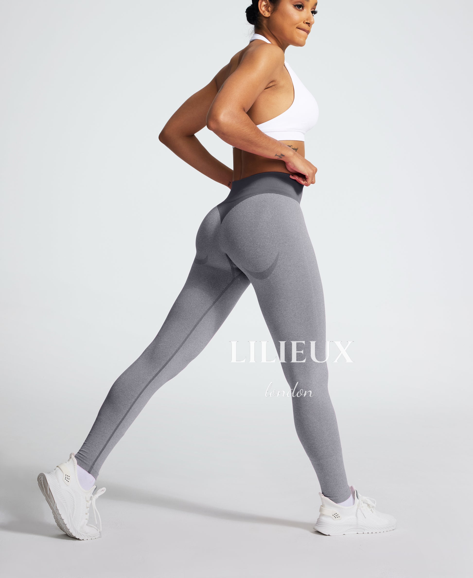 Model wearing grey high-waisted seamless leggings with a butt-lifting design, perfect for gym workouts, yoga, and fitness training.