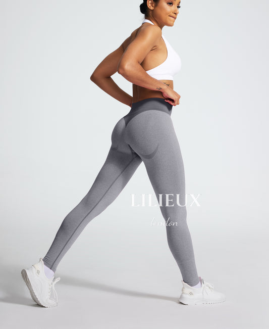 Model wearing grey high-waisted seamless leggings with a butt-lifting design, perfect for gym workouts, yoga, and fitness training.