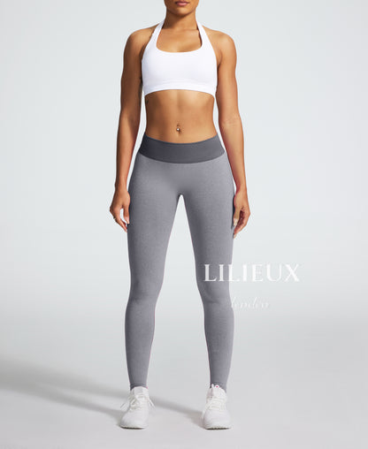 Front view of high-waisted grey seamless leggings for women, featuring a ribbed waistband and a snug fit for gym, yoga, and fitness activities.