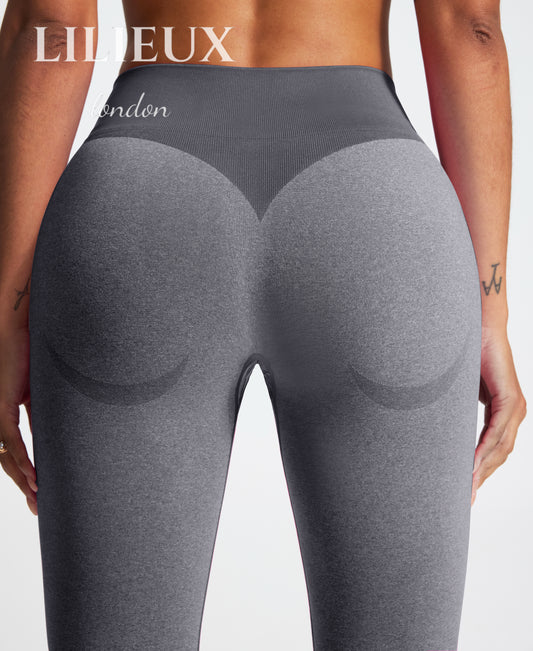 Detailed back view of scrunch-butt high-waist leggings in grey, highlighting contouring and shaping design for an enhanced fit during workouts.