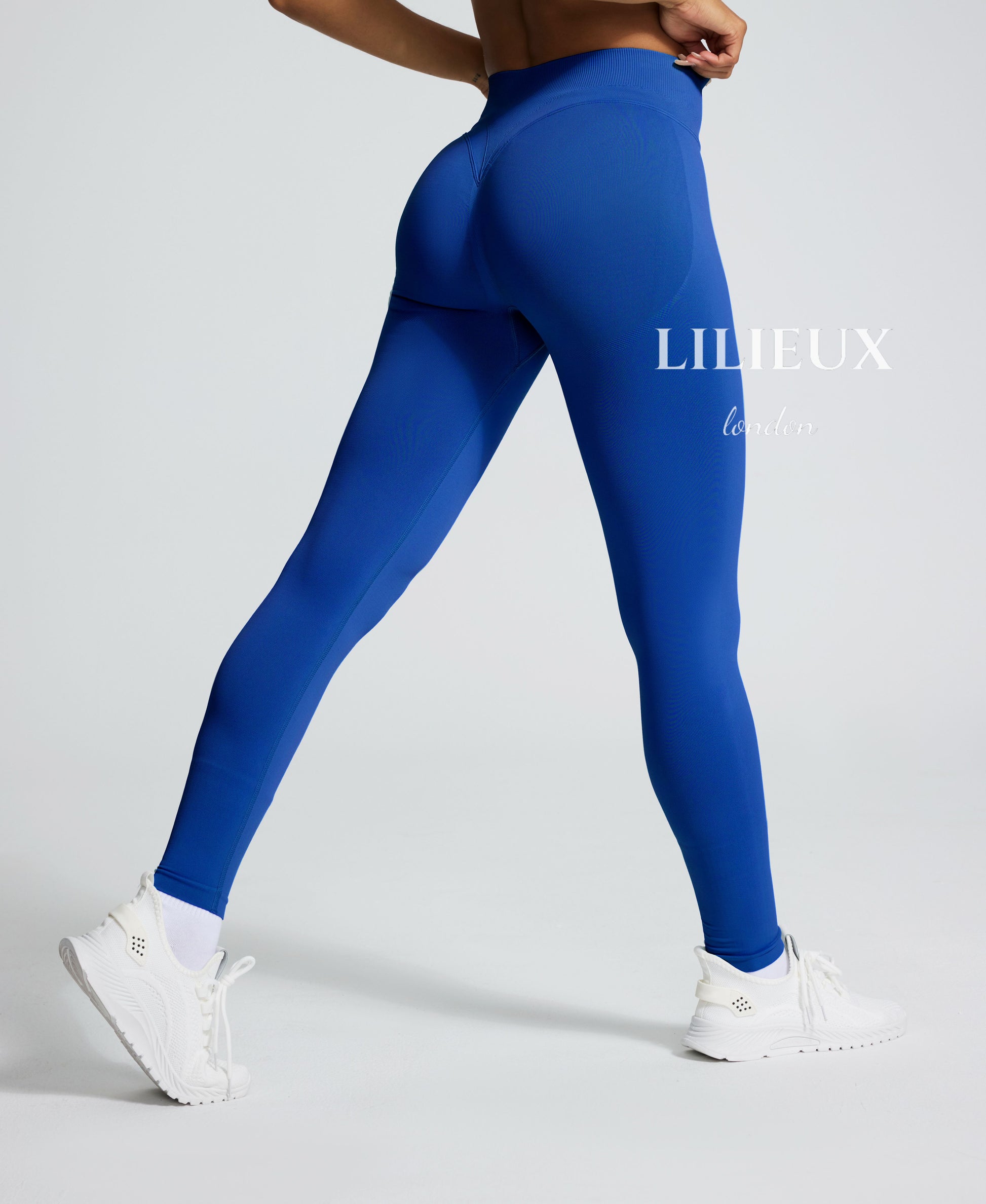 Women's seamless high-waisted blue leggings with a butt-lifting effect and contour-enhancing design, perfect for gym, yoga, and fitness training.
